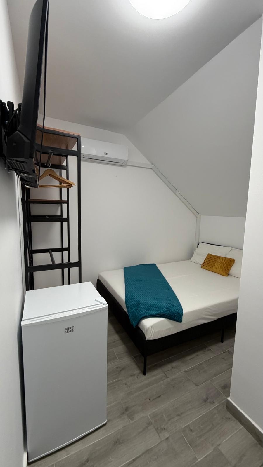 Camera la mansarda cu tavan inclinat, pat, TV si frigider la Radel House Costinesti